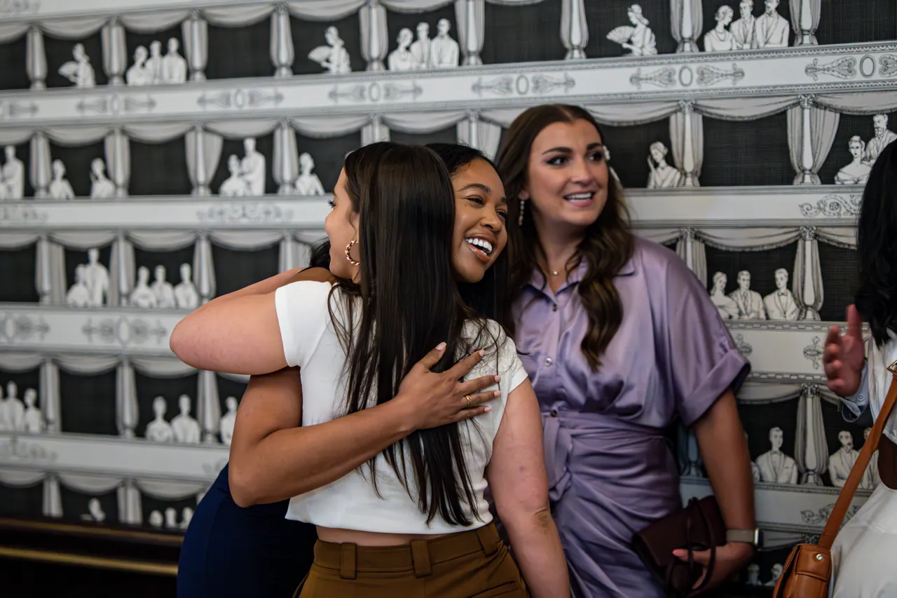 Guests laughing together at a dinner event