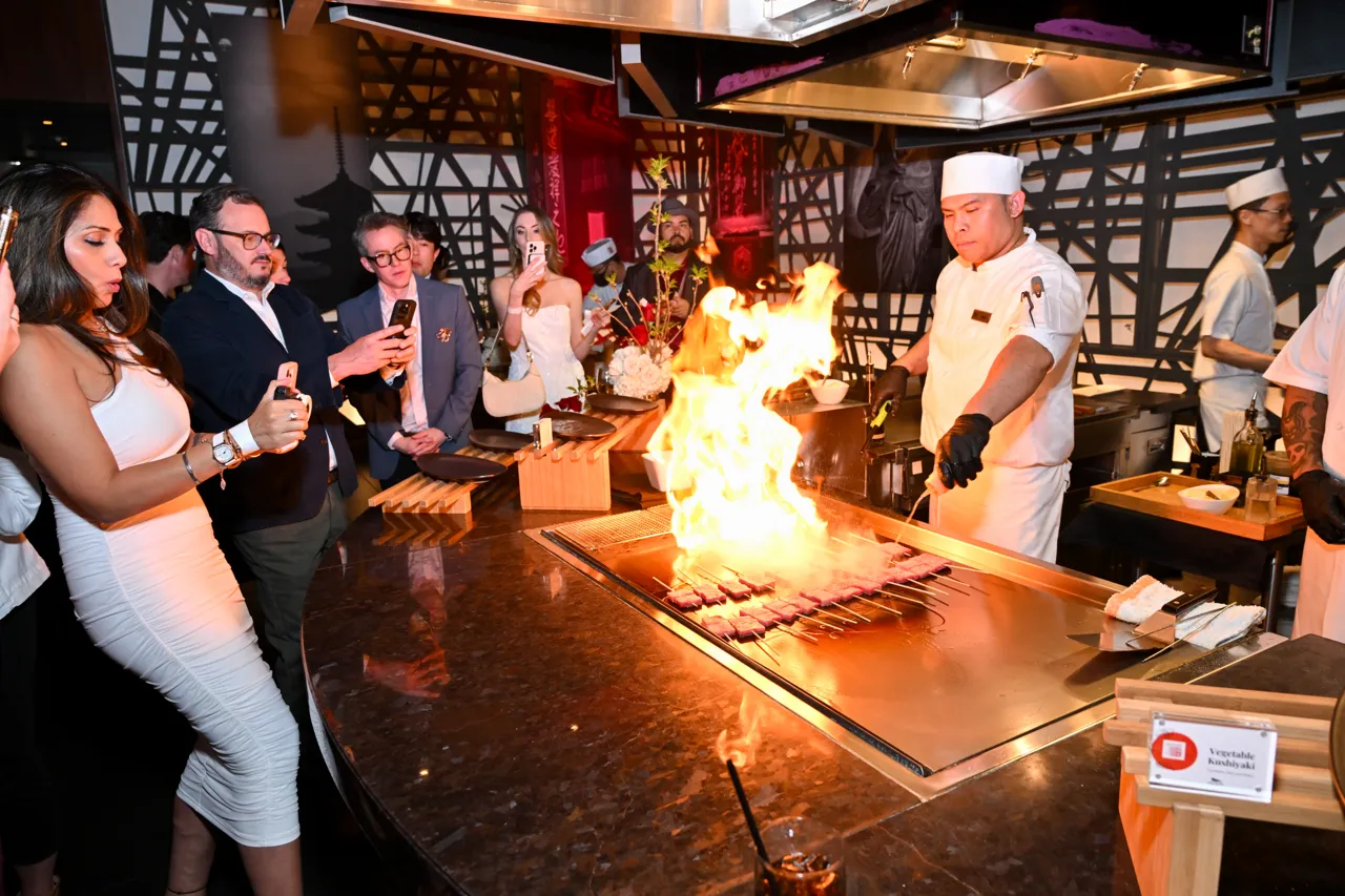 Guests watching a live cooking demonstration with flames — Morimoto, Las Vegas