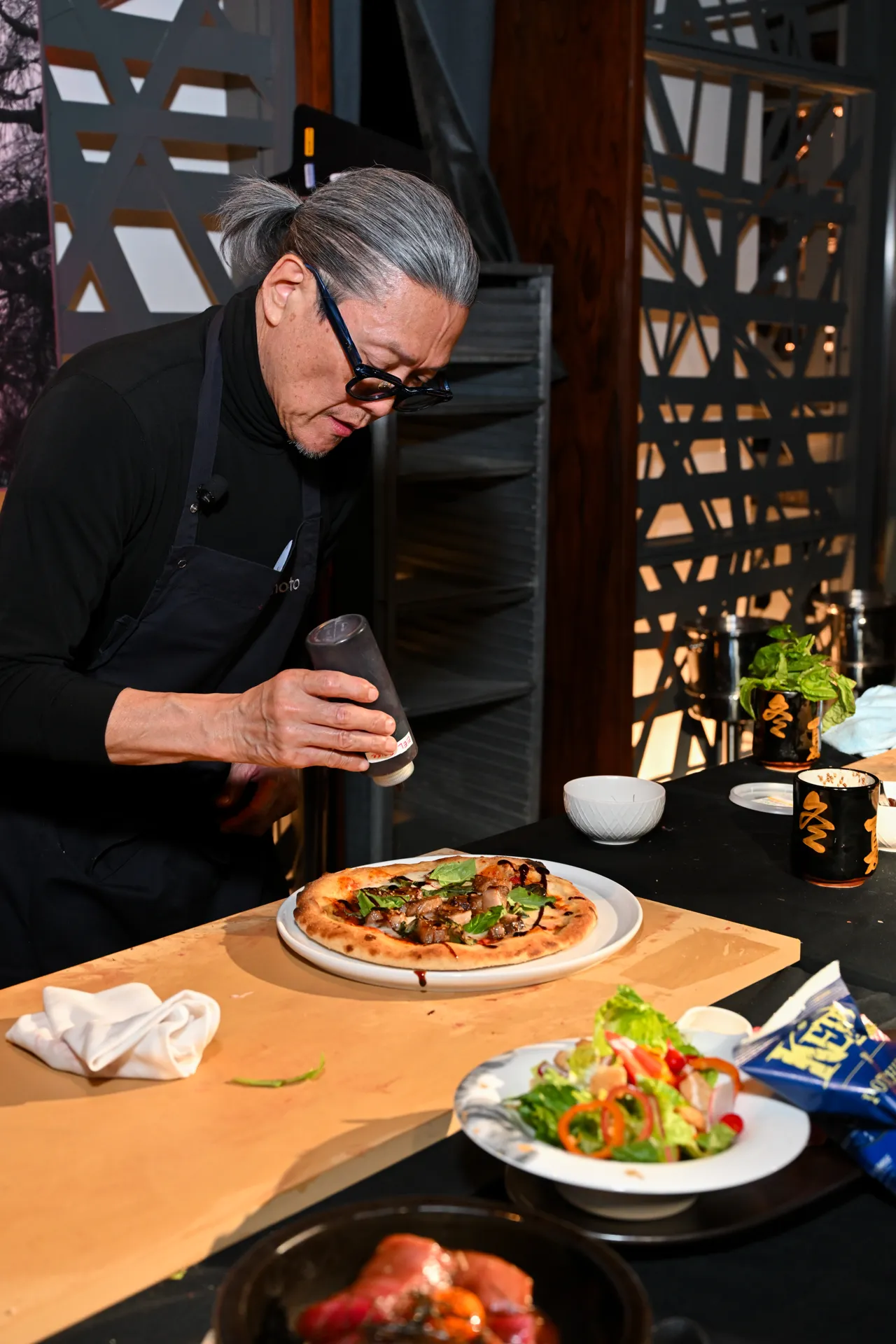Chef finishing a dish at the counter — Morimoto, Las Vegas
